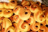 Yellow buns with raisins allegedly in the shape of cats.