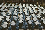 arial view of the tops of graduating class’s heads wearing mortar boards. Your graduating child