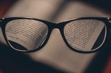glasses revealing the written content of a book
