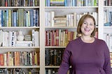 Color photo of novelist Jennifer Weiner with books