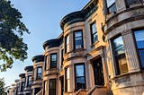 A block of brownstone apartments in Brooklyn as the sun sets