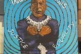 a large mural painting of John Lewis as Black Panther crossing his arms in a “Wakanda Forever” sign. With words that say Justice and Equality