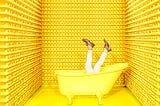 Man comically drowning in yellow bathtub surrounded by walls of rubber duckies.