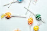 Colorful lollipops scattered against a white background