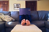 Person Sitting on Couch While Using Laptop Computer