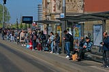A group of people waiting at a bus stop