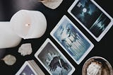 Tarot cards on a table with lit candles