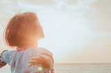 an image showing a woman enjoying the sunshine