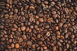 Close-up image of medium roast coffee beans.