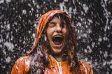 A girl shouting in the storm and rain.