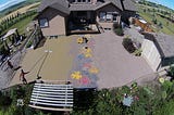 Stamped concrete patio being finished in Calgary. Workers are in the middle of placing fresh concrete and stamping a pattern in it while it’s still wet.