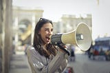 A girl announcing something on a loudspeaker