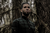 Attractive man in dense forest.