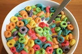 A bowl of sugary breakfast cereal and milk.