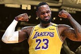 LeBron James flexing his arms in a Los Angeles Lakers jersey