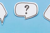 An image of three speech bubbles with question marks in them