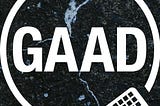 White “GAAD” text in a circle on a textured black background. A keyboard icon is in the corner, suggesting a tech theme.
