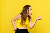 front-view-young-woman-talking-someone-yellow-wall