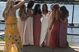 Friends posing for a wedding party photo