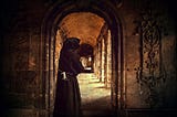Monk standing in a cloister doorway