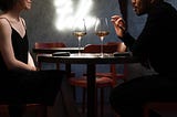 man articulating with his hands to a date over wine
