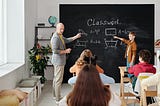 teacher teaching and managing a classroom of students