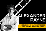 Alexander Payne standing in a white shirt with his arms crossed and a film roll behind him and the words “Alexander Payne Discusses His Casting Process: ‘I Love Having My Mind Blown!”