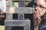 Woman removing a block during a stacking block game