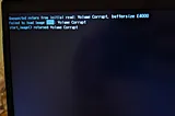 Photo of my laptop failing to boot, “failed to load image”, “Volume Corrupt”