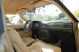 The front interior of a Volvo, seen through the open passenger-side door. The door itself is not in shot.