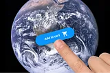 A finger touching an “Add to cart” button that is superimposed on an image of planet Earth