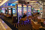 Elderly man plays a slot machine at a casino