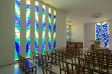 Behind the altar in the nave of the Matisse Chapel are the artist’s “Tree of Life” windows. (Claude Almodovar/© 2019 Succession H. Matisse/Artists Rights Society (ARS), New York)