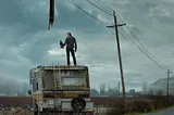 a scene from the post-apocalyptic world where a deadly plague has wiped out most of humanity. The person on the trailer is one of the survivors who has to choose between the forces of good and evil. The object in their hand is a walkie-talkie, which they use to communicate with other survivors. The broken utility pole represents the collapse of civilization and the loss of power. The text on the image says The Stand
