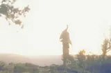 A sunrise mirage of a man in the distance on the rim of the Grand Canyon.