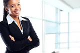 A young black business woman standing with folded arms