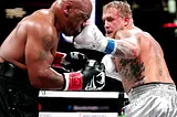 Jake Paul defeats Mike Tyson via unanimous decision in boxing match.