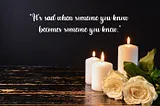 Burning candles with white roses in a dark background along with a sad quote about life