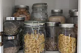 Pantry stocked with bulk items in jars