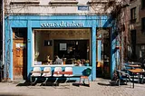 Image of an open air cafe with tables outside