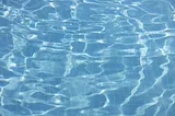 The clear blue water of a swimming pool