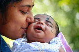 Mother kissing a child