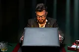 Man looking inside a briefcase.