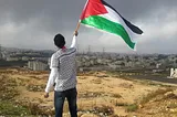 Man waving Palestinian flag.