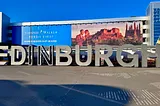 Image of the Edinburgh sign at the airport - image courtesy of the author.
