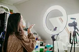 Young woman recording video for social media