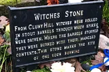 A plaque above the Witches Stone describing the treatment of suspected witches.