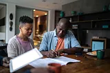 Two people sitting at a table.