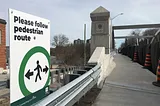 sign announcing pedestrian route across new bridge