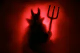 silhouette of a devil on red